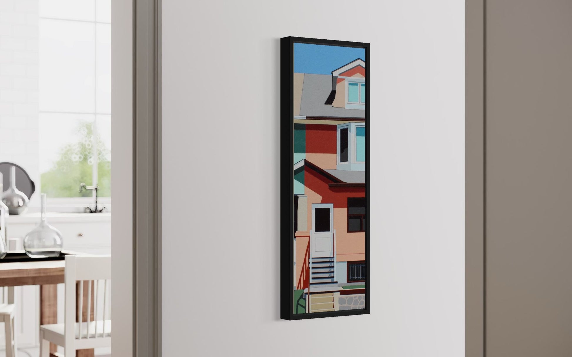 Framed abstract art on a wall in a room with a window and table.