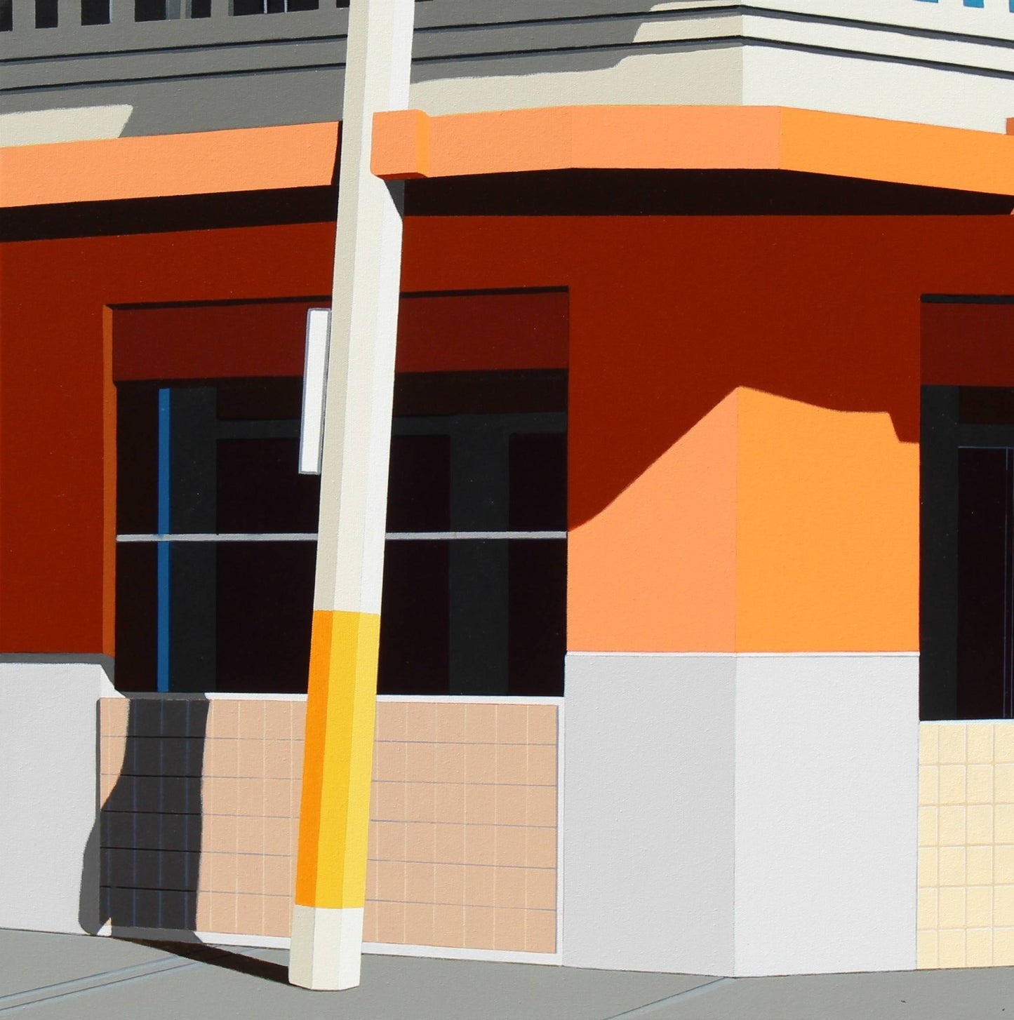 Colorful geometric building with a tall white pole in front