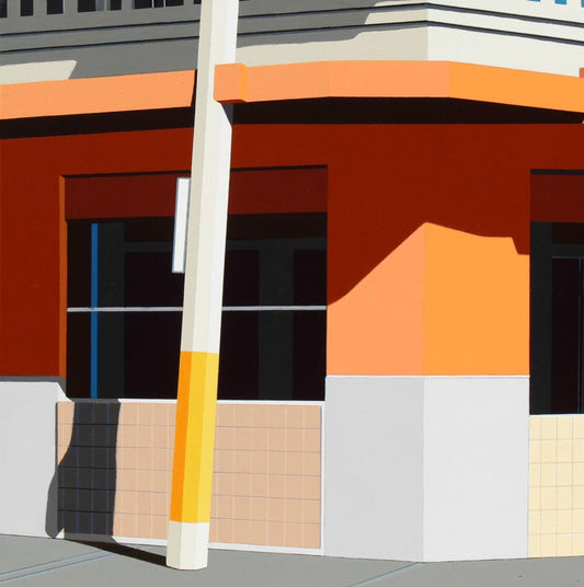 Colorful geometric building with a tall white pole in front