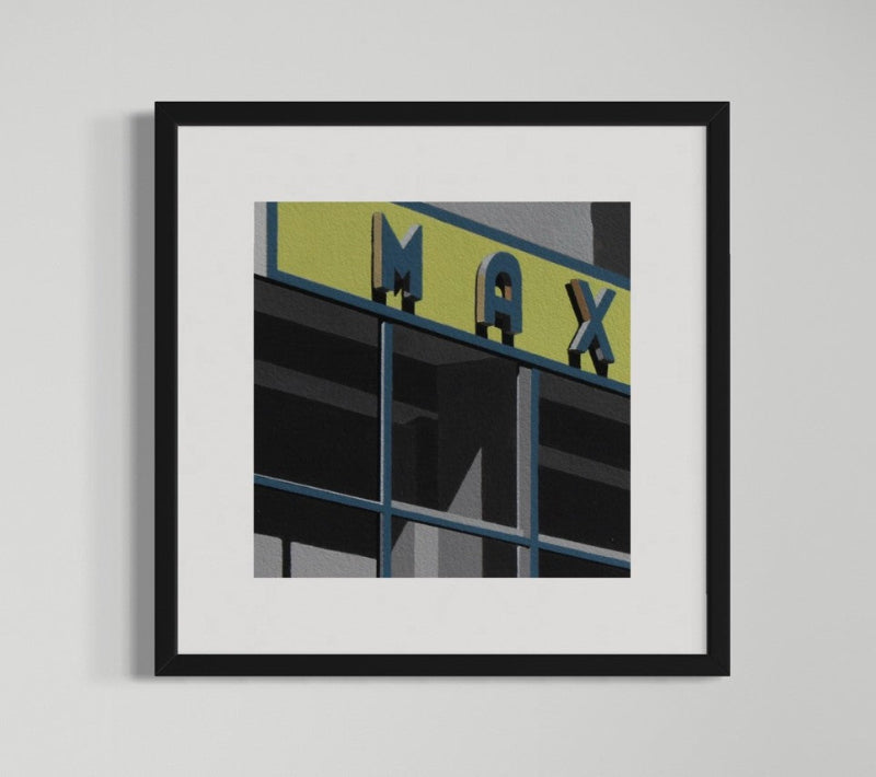 Framed artwork of a building facade with 'MAX' sign on a gray background