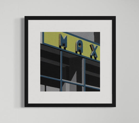 Framed artwork of a building facade with 'MAX' sign on a gray background