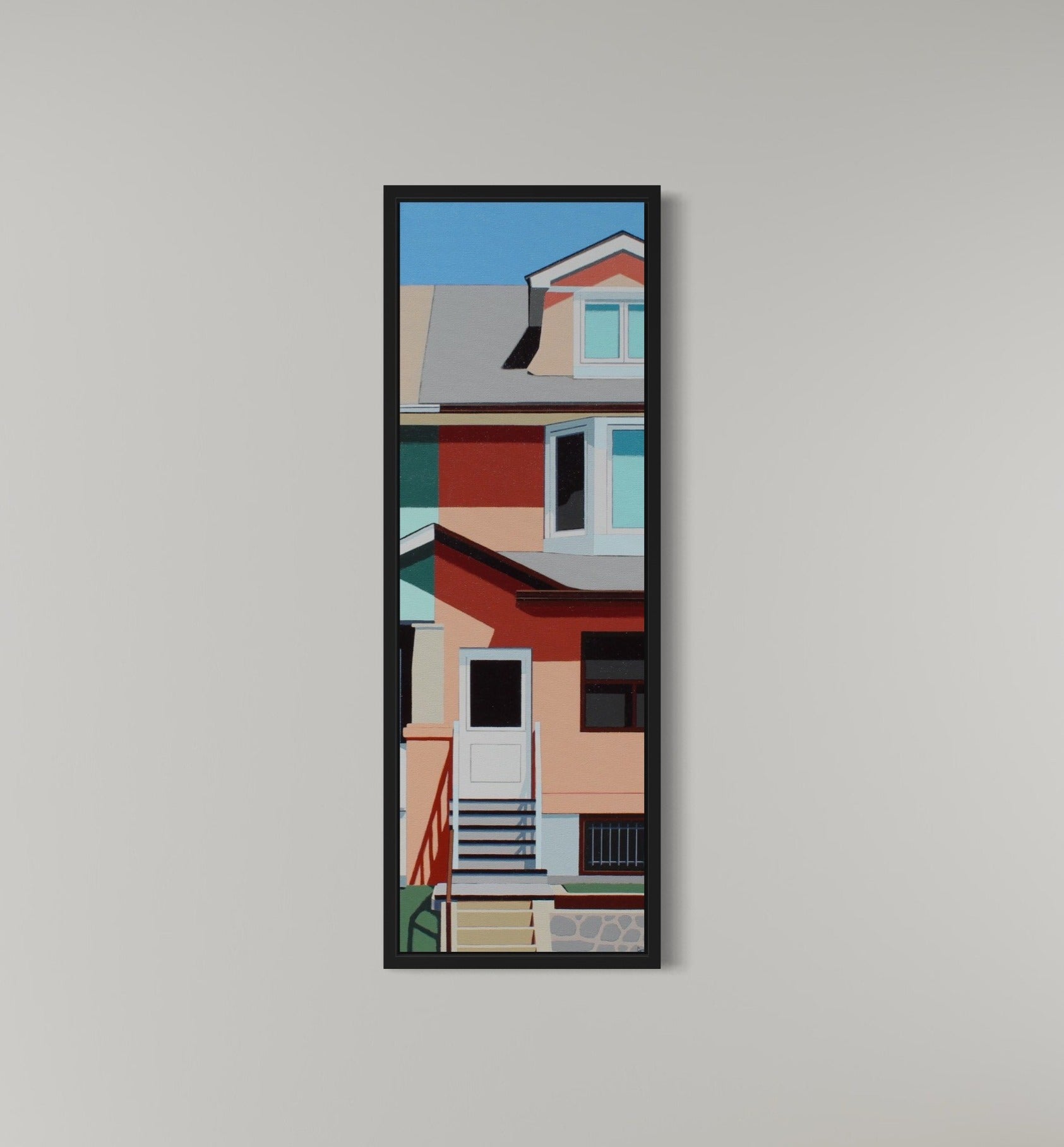 Framed artwork of a colorful architectural scene on a gray wall